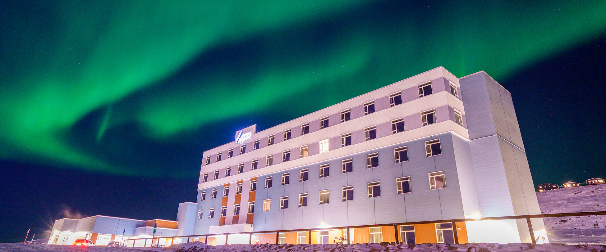 Hotel with green northern lights above