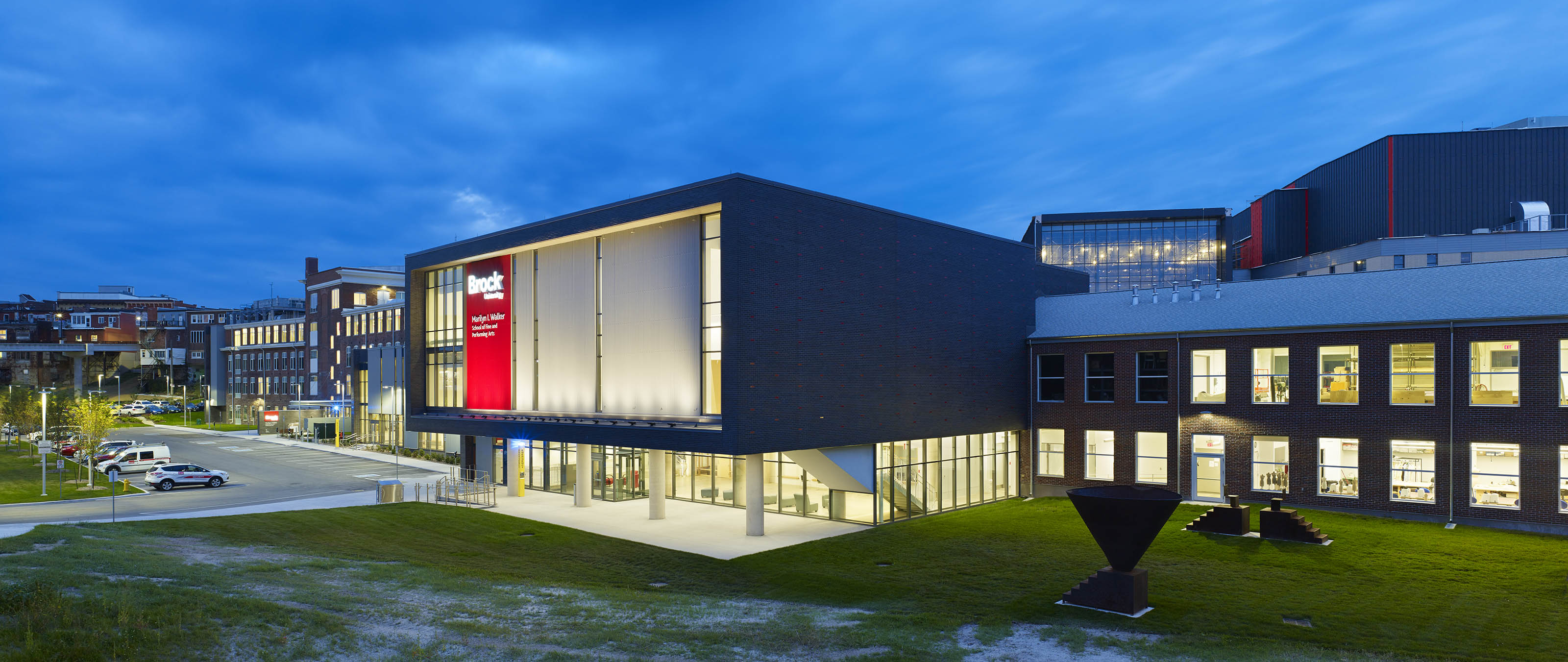Brock University's Marilyn I. Walker School of Fine & Performing Arts exterior lit at night 