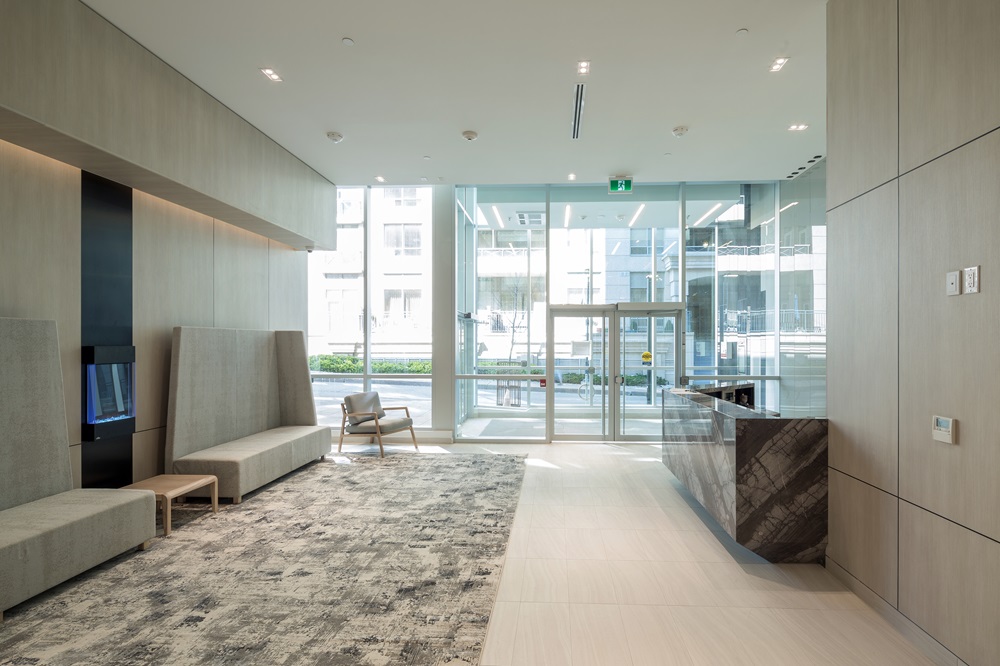 Lobby with glass doors and light wood panel walls