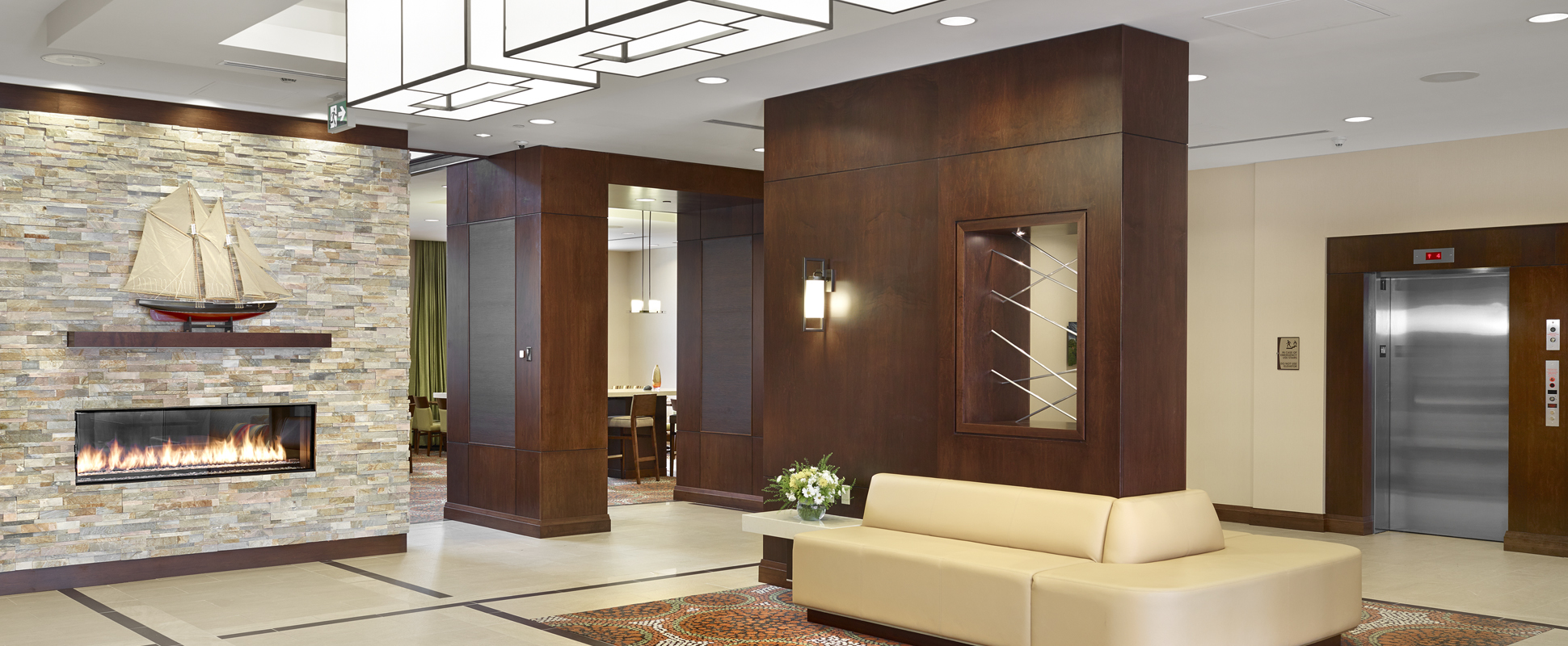 Hampton Inn and Homewood Suites interior lobby showing fireplace and seating area