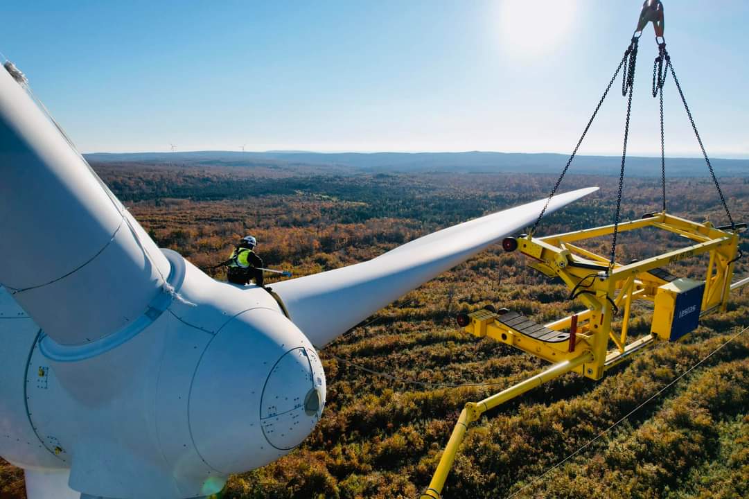 Worker on top of wind turbine