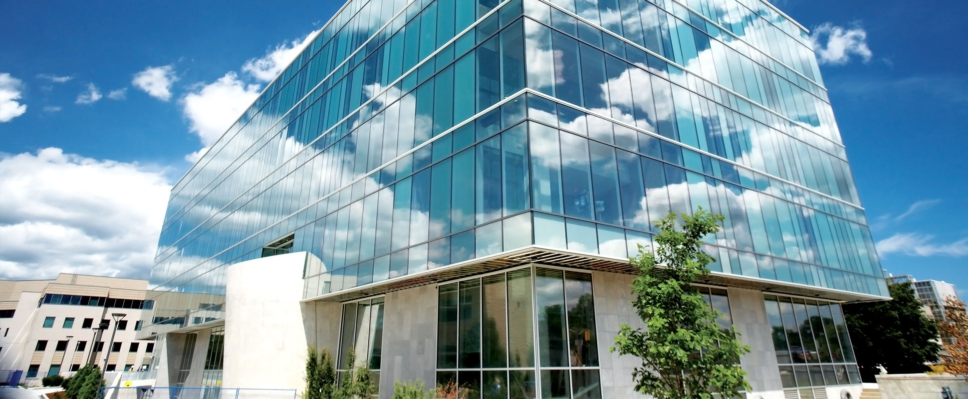 McMaster Engineering Technology Building exterior with clouds reflected in glass facade 